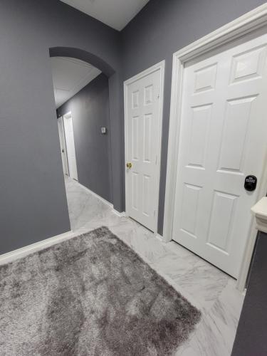 an empty room with a white door and a rug at Nice & Cozy Bedroom at GP's in Grand Prairie
