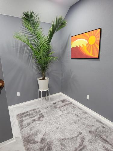 a room with a potted plant on the wall at Nice & Cozy Bedroom at GP's in Grand Prairie