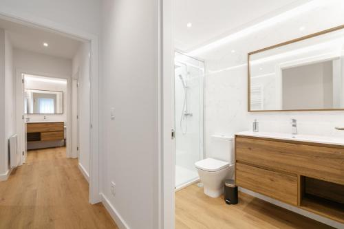 a bathroom with a sink and a toilet and a mirror at LUXURY SILGAR in Sanxenxo