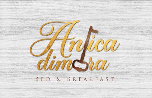 a sign for a bed and breakfast restaurant with a gold cursiveigraphy at B&b Antica Dimora in Chiaromonte