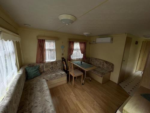 a living room with a couch and a table at Autocamp Free Star - Mobilheimy in Strachotín