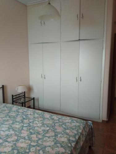 a bedroom with white cabinets and a bed at THEO house in Kyllini Zakynthos in Kyllini