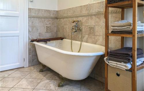 a white bath tub in a bathroom with towels at Awesome Home In Nysted With Wifi in Nysted