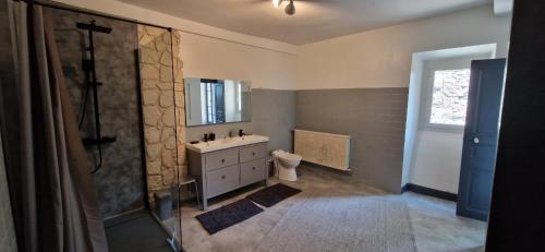 a bathroom with a sink and a toilet and a mirror at Spacieuse Maison de ville - Quartier Calme - 10 Personnes in Oloron-Sainte-Marie