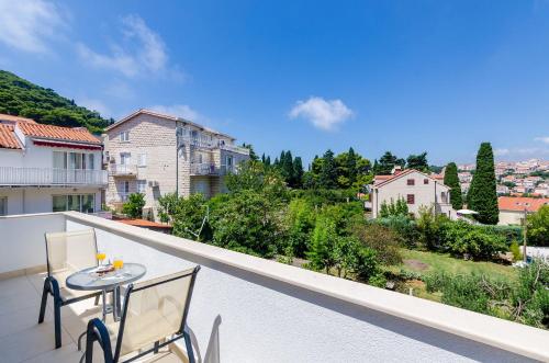 a patio with a table and chairs on a balcony at Apartments & Rooms V&M in Dubrovnik