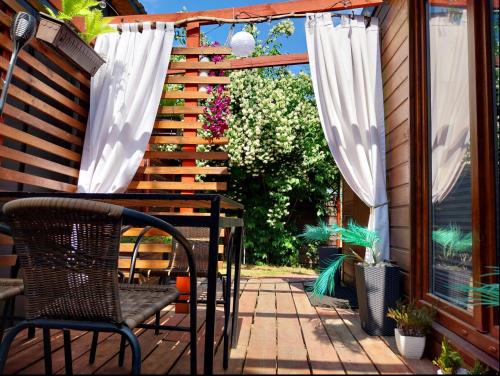 a patio with a table and chairs on a deck at Apartament Antonio 2 Gdańsk in Gdańsk