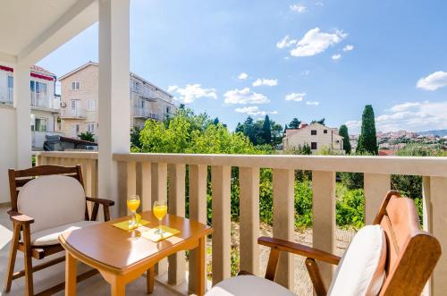 a balcony with a table and two glasses of wine at Apartments & Rooms V&M in Dubrovnik