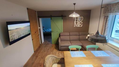 a living room with a table and a couch at apartman šumiac 5 in Šumiac