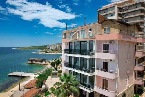 a building with a view of the ocean at Hotel Piccolino in Sarandë