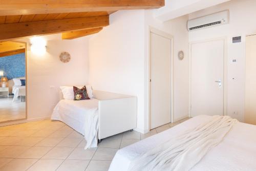 a bedroom with two beds and a living room at Hotel Balaton in Riccione
