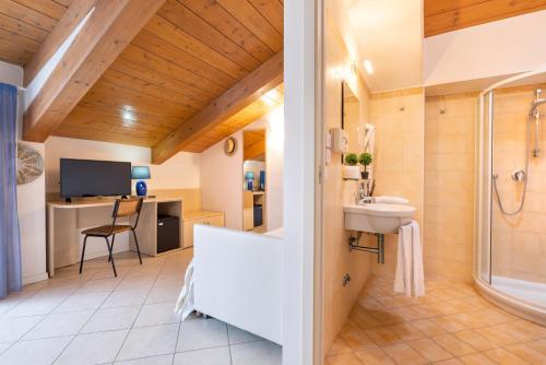 a bathroom with a shower and a sink and a toilet at Hotel Balaton in Riccione