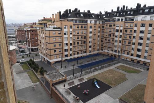 an aerial view of a city with tall buildings at Acogedor Apartamento en Oviedo Frente al HUCA in Oviedo