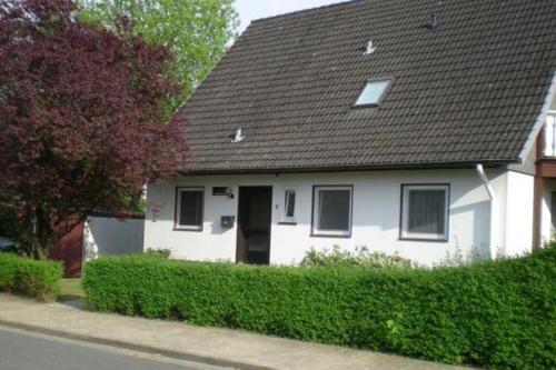 a white house with a black roof at Ferienwohnung Machate in Bad Bevensen