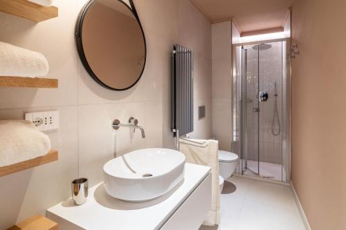 a bathroom with a sink and a mirror on the wall at Aosta Holiday Apartments - Sant'Anselmo in Aosta