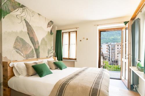 una camera con un grande letto e una grande finestra di Aosta Holiday Apartments - Sant'Anselmo ad Aosta