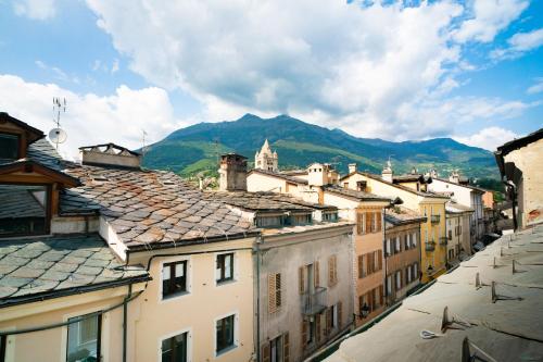 a view of a city with buildings and a mountain at Aosta Holiday Apartments - Sant'Anselmo in Aosta