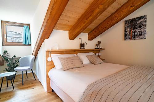 a bedroom with a bed in a room with wooden ceilings at Aosta Holiday Apartments - Sant'Anselmo in Aosta