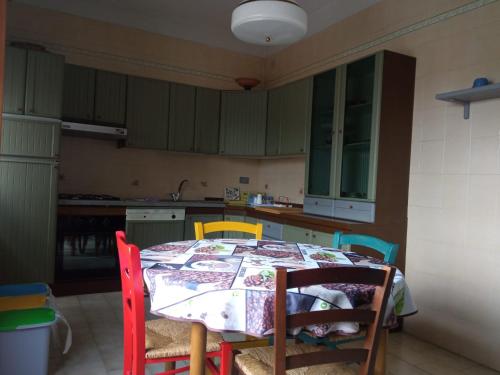 a kitchen with a table with chairs and a table and a table at Il Giardino degli Agrumi in Caserta