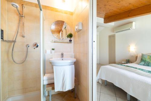 a bathroom with a shower and a sink at Hotel Balaton in Riccione