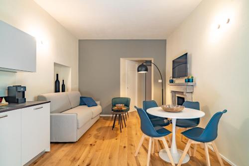 a kitchen and a living room with a table and chairs at Aosta Holiday Apartments - Sant'Anselmo in Aosta