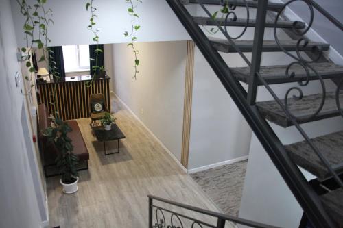a spiral staircase in a house with plants at Jardin in Aktobe