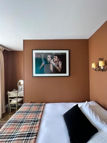 sypialnia z łóżkiem z obrazem na ścianie w obiekcie Centre historique de LYONS LA FORET Hotel de Maître le Cottage w mieście Lyons-la-Forêt