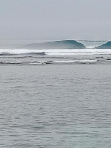 a body of water with waves in the ocean at Rumah Nalu surf camp in Krui
