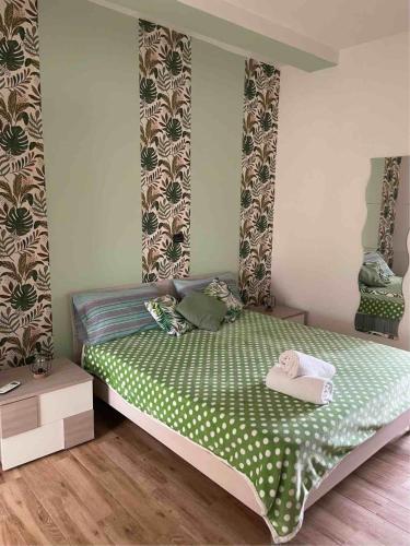 a bedroom with a bed with a green comforter at Vista Mare - Case Vacanza in Taranto