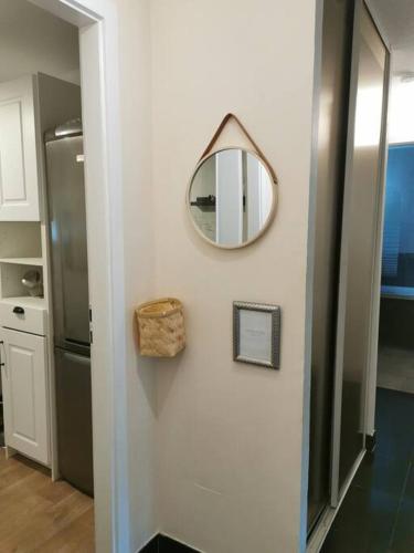 a mirror hanging on a wall in a kitchen at appartement cosy à 10 min du centre de Strasbourg in Strasbourg