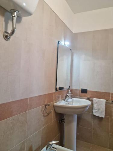 a bathroom with a sink and a mirror at Arbus dune e mare in Arbus