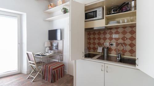 a kitchen with a sink and a table in a room at Italianway - Argelati 2 in Milan