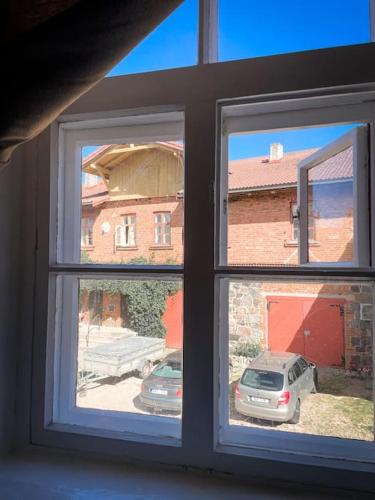 a window with a view of a car parked outside at Fairytale apartment in Viljandi old town in Viljandi