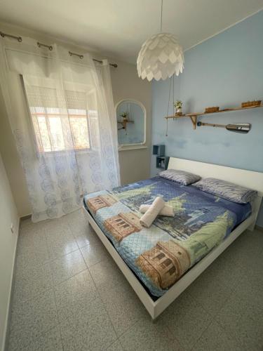 a bedroom with a bed and a large window at Anirè - Case Vacanze in Taranto