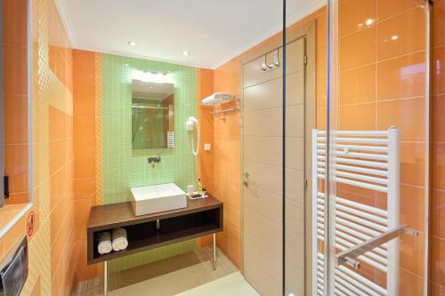 a bathroom with a sink and a glass shower at Villa Serena, Eastern Corfu in Kato Korakiana