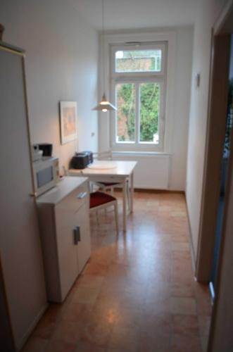 a small kitchen with a table and a window at Ferienwohnungen Ehlers-Bastelstudio in Bad Bevensen