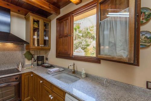a kitchen with a sink and a window at VILLA TAMARIT in Pedralba
