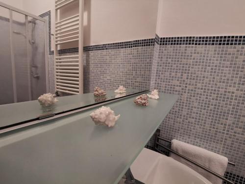 a bathroom with a counter with flowers on it at Il Vico in Gaeta