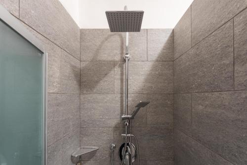a bathroom with a shower with a shower head at La Casa di Vitto by Wonderful Italy in Turin