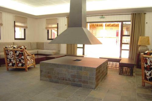 a living room with a table in the middle at Lagrange Vacances Les Chalets d’Ax in Ax-les-Thermes