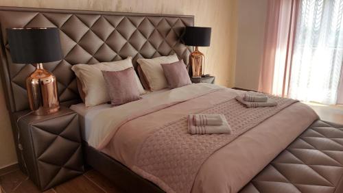 a bedroom with a large bed with a large headboard at Kuca za odmor Damir in Šmrika