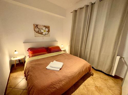 a bedroom with a bed with two towels on it at Apartments Labinac in Pula