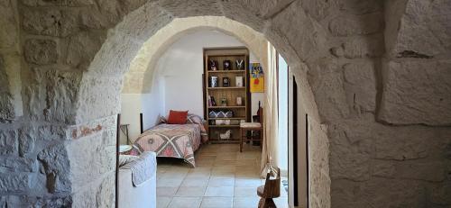 an archway in a stone building with a bedroom at Trulli Giovanni e Angela in Locorotondo
