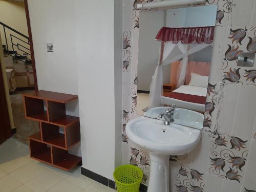 a bathroom with a sink and a bunk bed at Villa Martis Kakamega in Kakamega