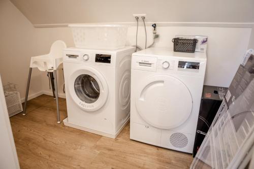 a white washer and dryer in a laundry room at Prachtig 6-persoons appartement in Yerseke