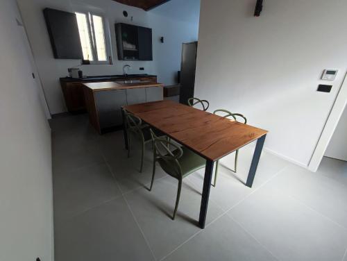 een keuken met een houten tafel en een aantal stoelen bij Marconi Apartment in Chieri
