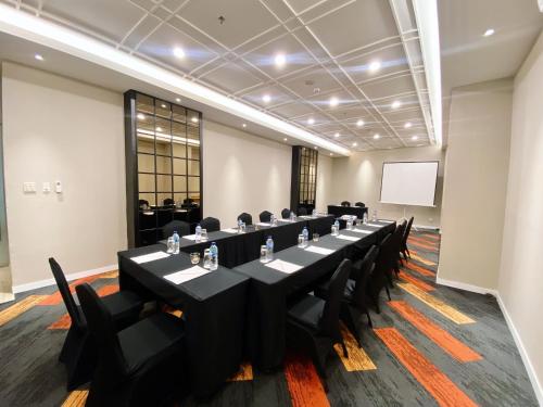 a conference room with a long table and chairs at Grand Zuri Malioboro in Yogyakarta