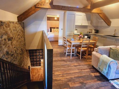 a kitchen and living room with a dining room and a table at Blackberry Barn in Ballymena