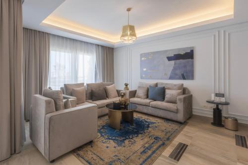 a living room with two couches and a table at Gewan Resort New Alamein in El Alamein
