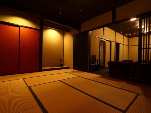 an empty room with mats on the floor at Ryokan Karasawa in Kanazawa