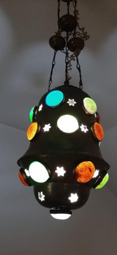 a black chandelier hanging from a ceiling at Sa Prenda E Oro in Ulà Tirso